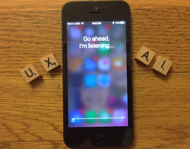 iPhone with words on screen: Go ahead, I'm listening. Surrounded by scrabble letters UX and AI
